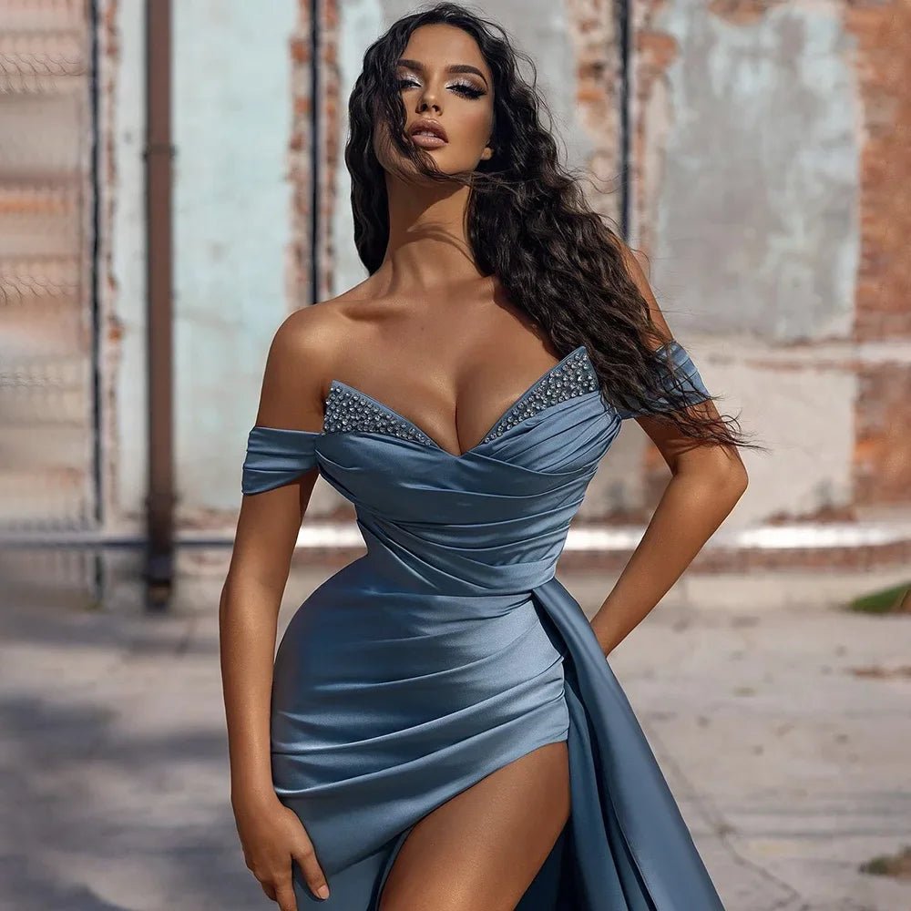 close-up of girl wearing a dusty blue off the shoulder beaded satin slit prom dress