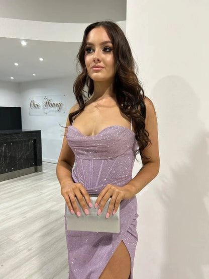 detailed front view of girl wearing a lavender sequined thigh slit prom dress with spaghetti straps