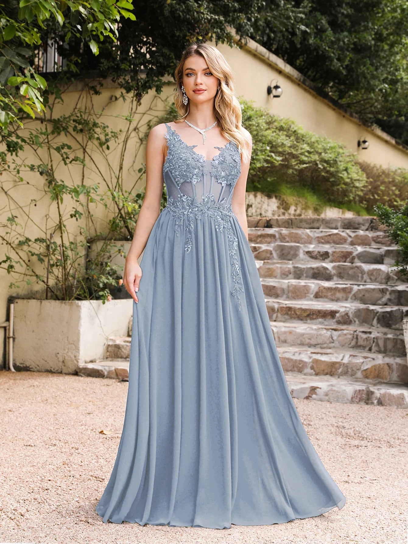 full front view of a girl wearing a grey-blue luxury backless beaded a-line prom dress