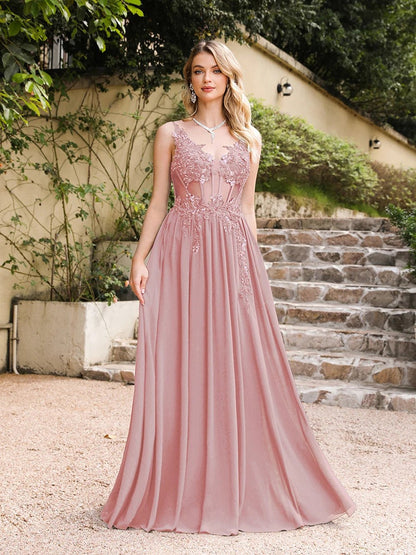 front view of girl outside wearing a pink luxury backless beaded a-line prom dress