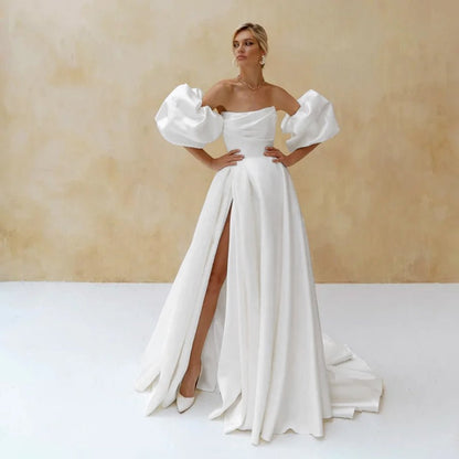 Full front view of a bride wearing an Elegant White A-Line Side-Slit Satin Wedding Dress with Puff Sleeves