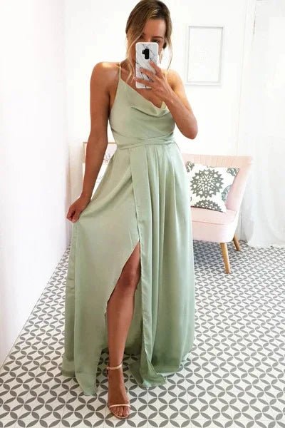 girl taking a selfie wearing mint green satin side slit backless prom dress with spaghetti straps