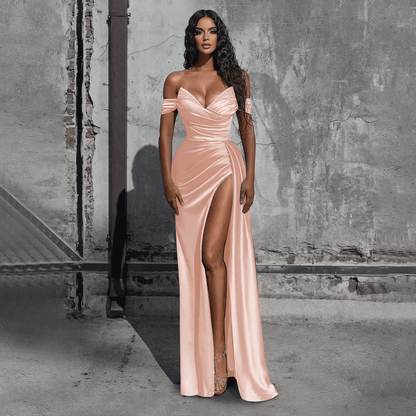 girl wearing a blushing pink off-the-shoulder beaded satin slit prom dress