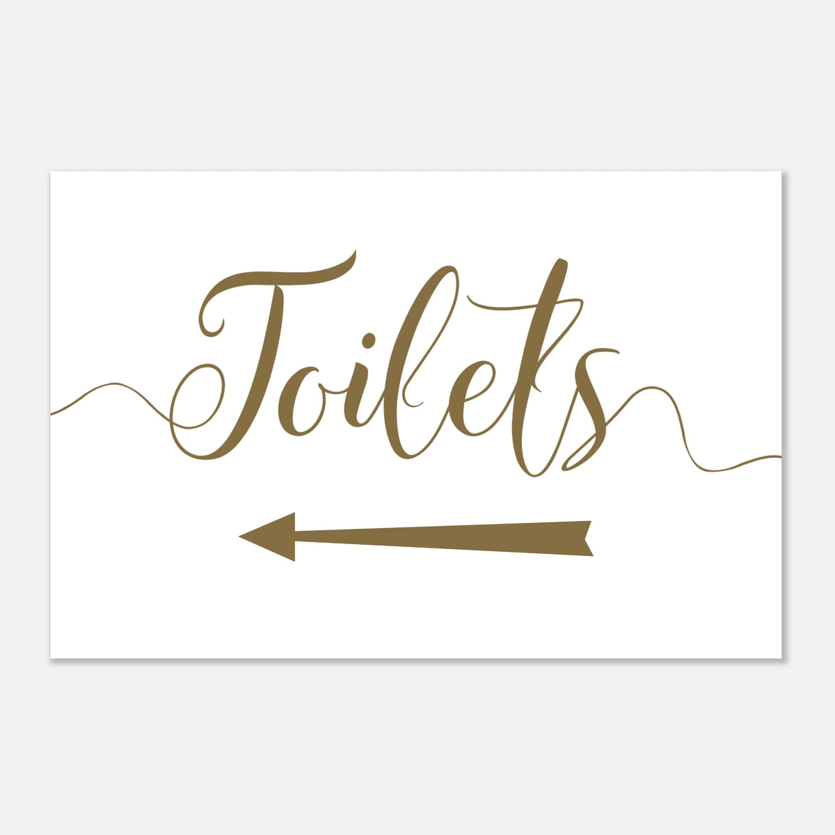 A white rectangular sign with the word 'Toilets' in brown cursive script and a brown left-pointing arrow below, shown on a light gray background.