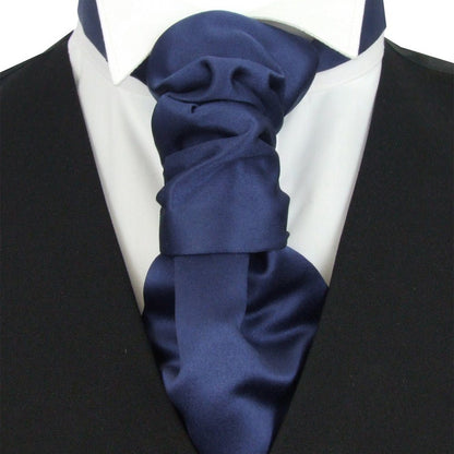 Navy blue ascot tie on a white shirt with a black suit jacket.
