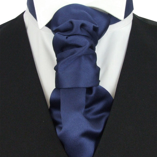 Navy blue ascot tie on a white shirt with a black suit jacket.