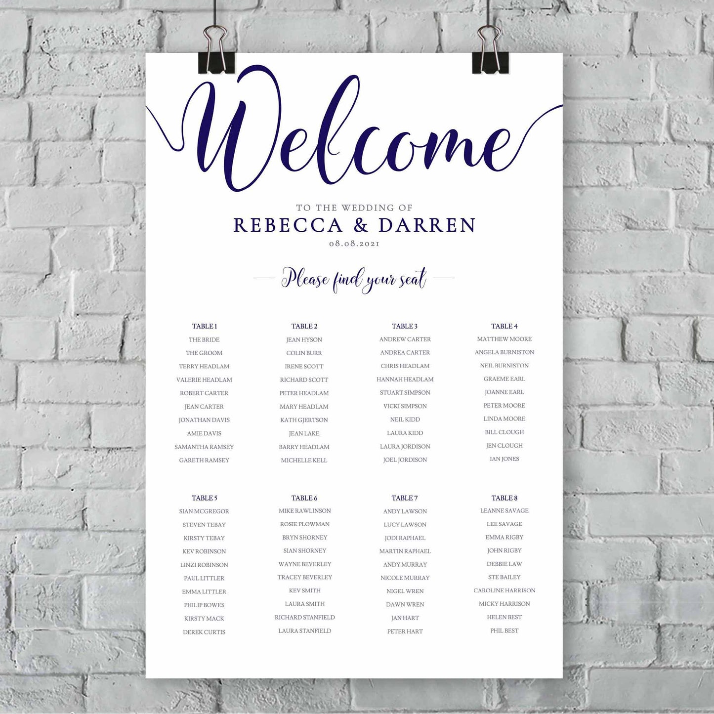 navy outdoor wedding seating chart with 8 tables hanging from a wall
