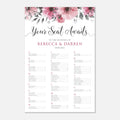 A wedding seating chart print with a floral header featuring pink watercolor flowers and green leaves on a white background. The text reads 'Your Seat Awaits' and includes the wedding names 'Rebecca & Darren' and a date, with rows of alphabet seating assignments below.