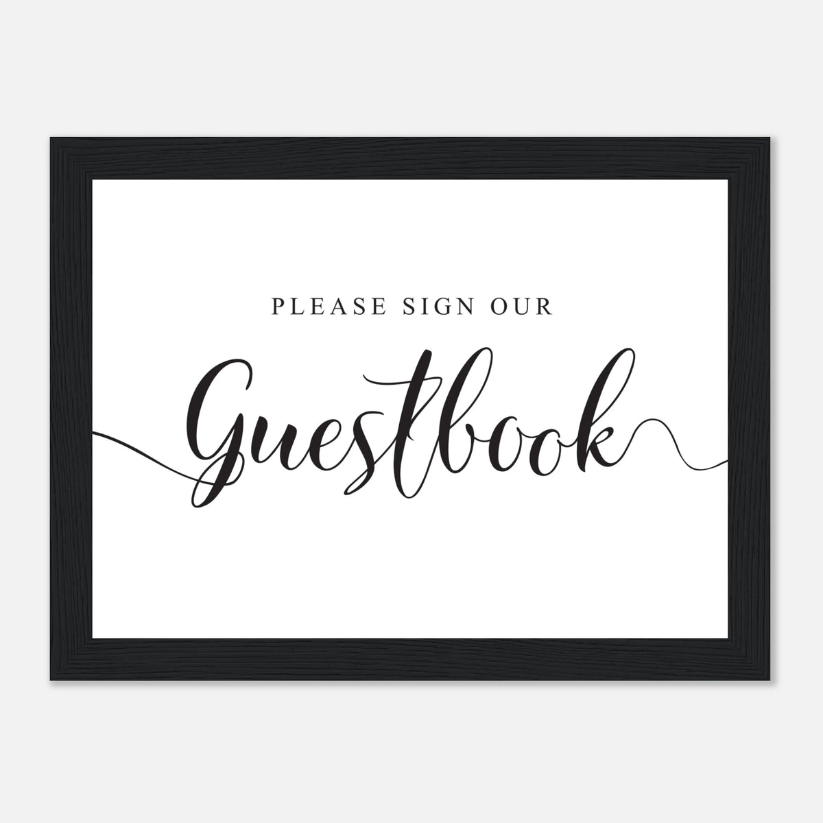 A framed guestbook sign with a black frame and a white background. The text reads 'PLEASE SIGN OUR Guestbook' in black lettering, with 'Guestbook' in a large cursive font.