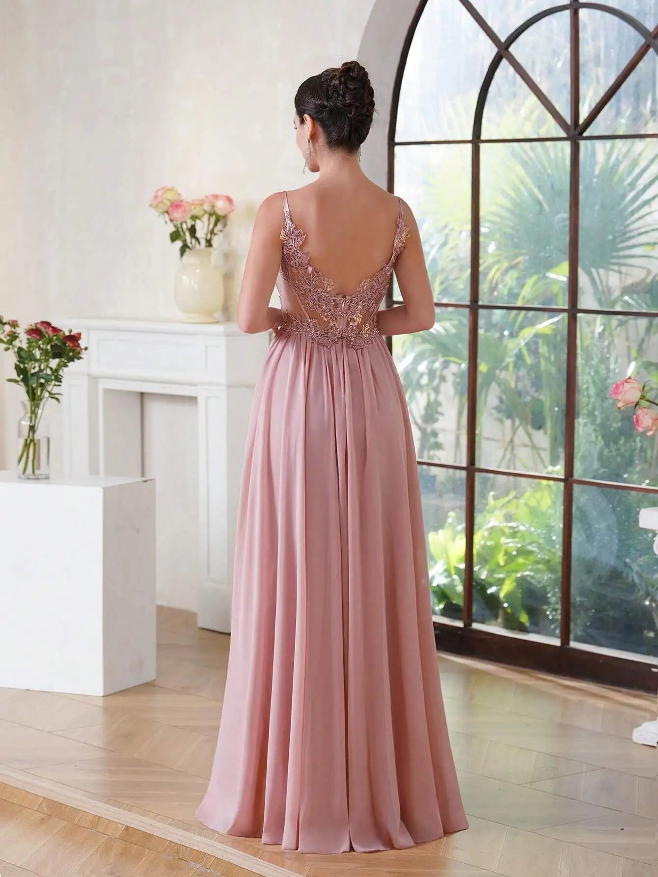 rear view of a girl wearing a pink luxury backless beaded a-line prom dress