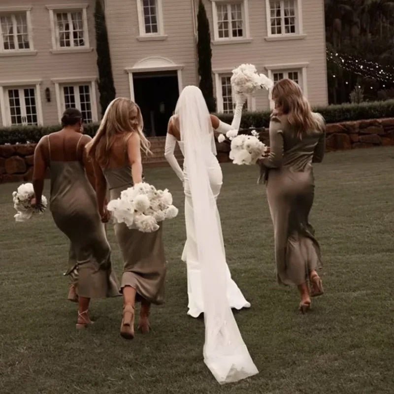 rear view of bride and bridesmaids wearing a white Off-the-Shoulder Modern Satin Mermaid Wedding Dress with Long Sleeves