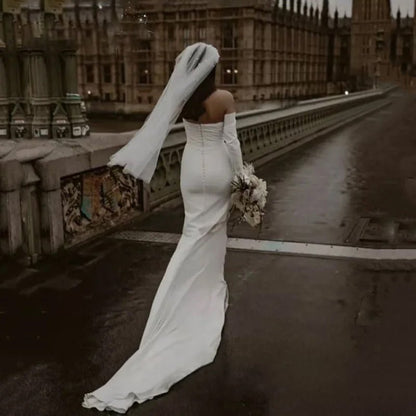 rear view of bride on london bridge wearing a white Off-the-Shoulder Modern Satin Mermaid Wedding Dress with Long Sleeves