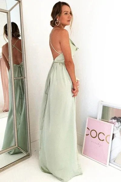 side view of girl wearing mint green satin side slit backless prom dress with spaghetti straps