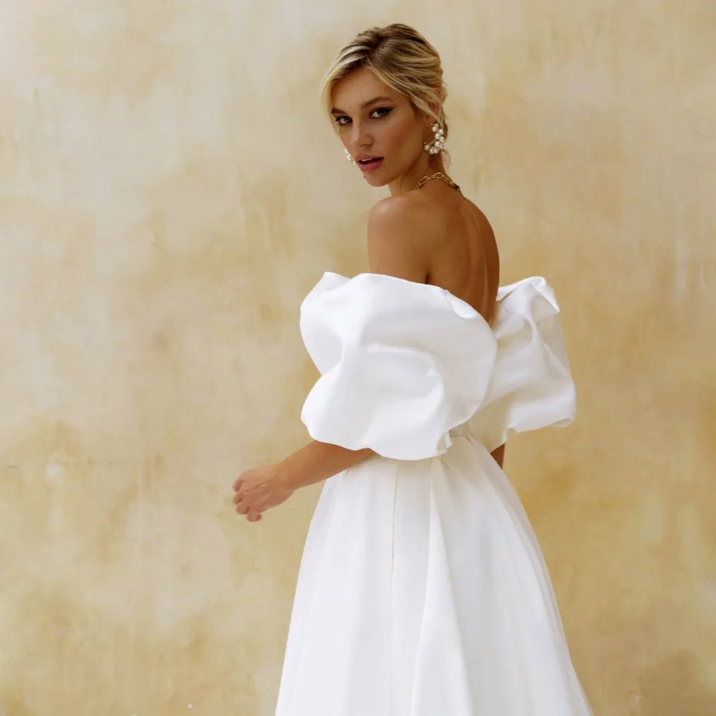 sideways view of bride wearing Elegant A-Line Side-Slit Satin Wedding Dress with Puff Sleeves