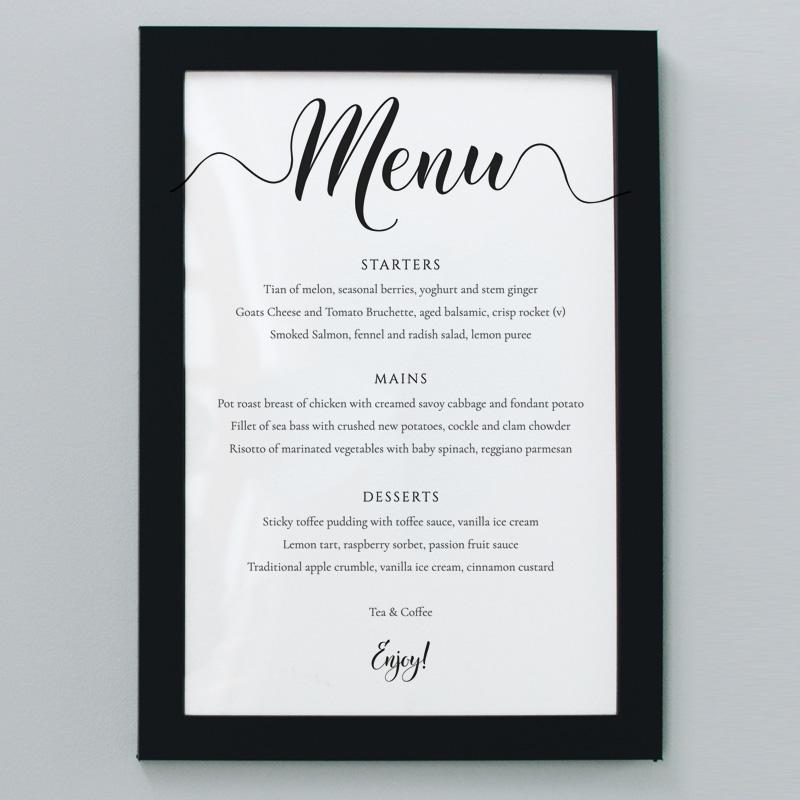 Printed black and white 5"x7" wedding menu in a black picture frame