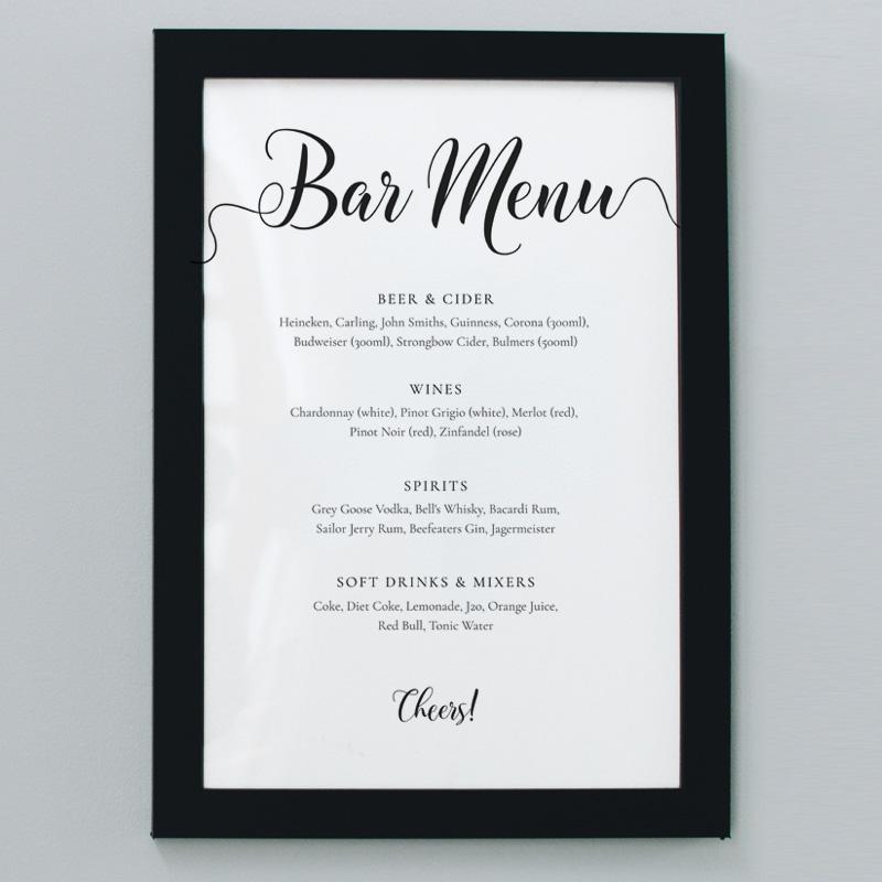 8x10 wedding bar menu in a black frame on the wall