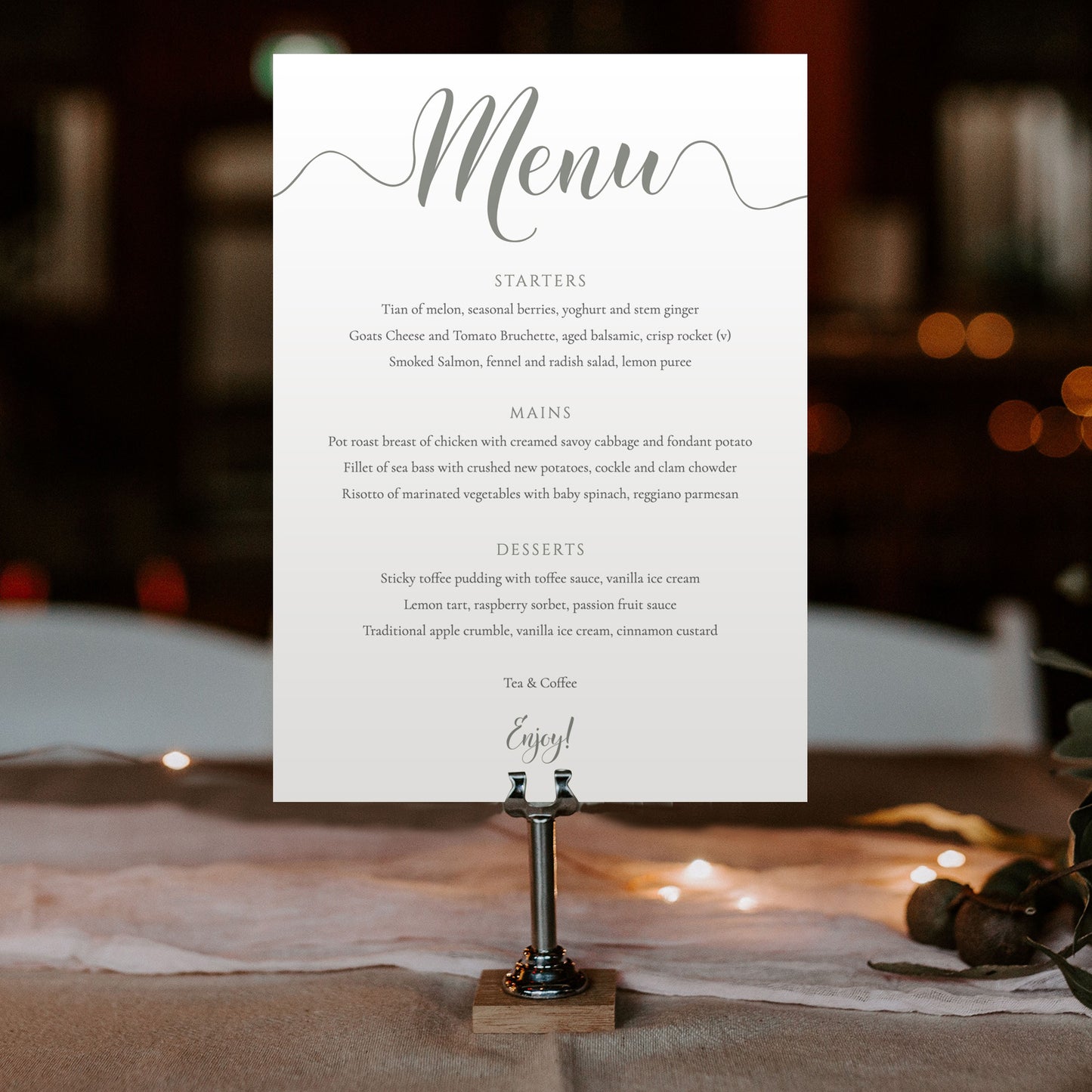 5x7 misty green menu card in a menu stand at a wedding