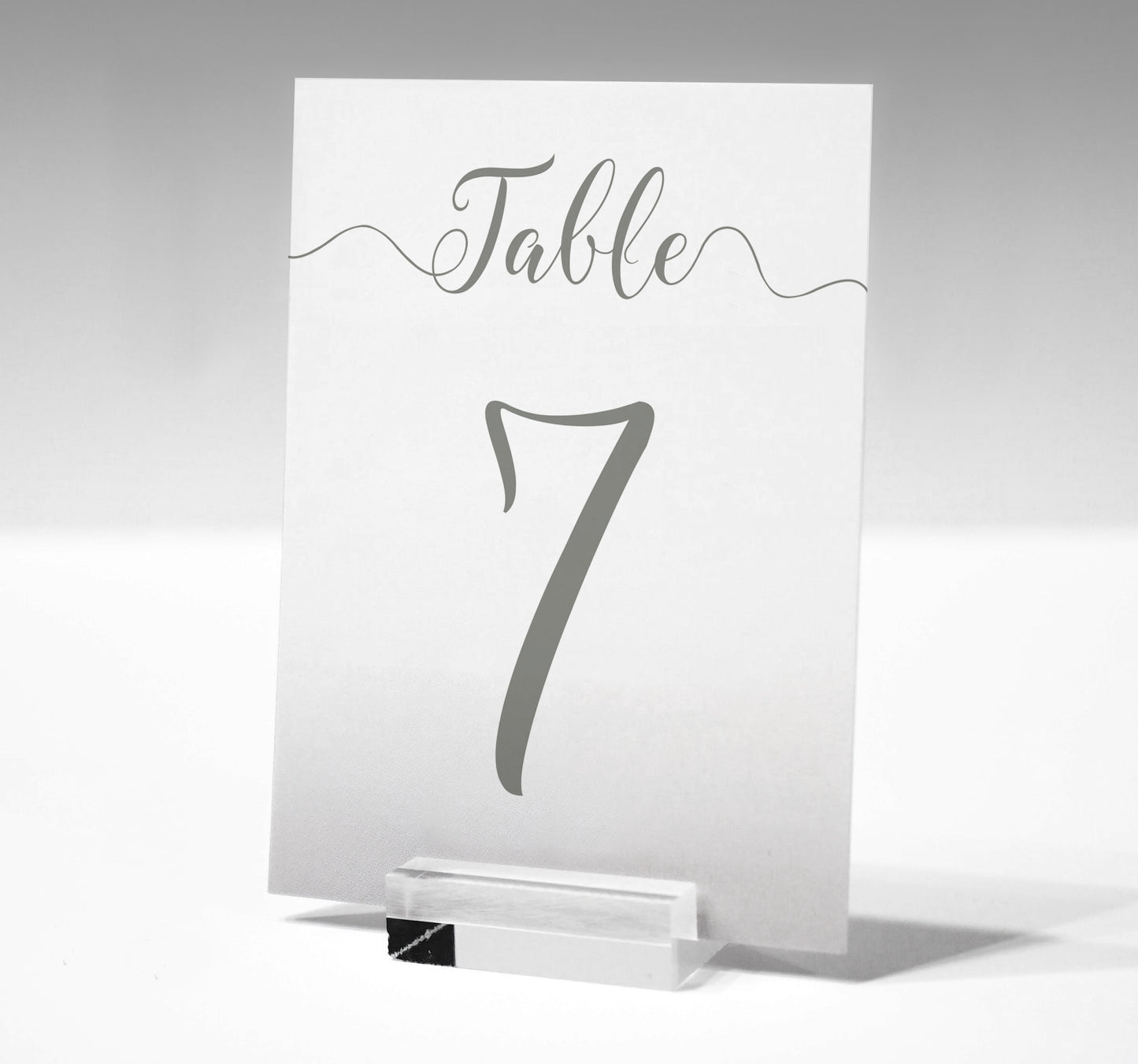 7x5 sage green table number printed on card in a glass stand