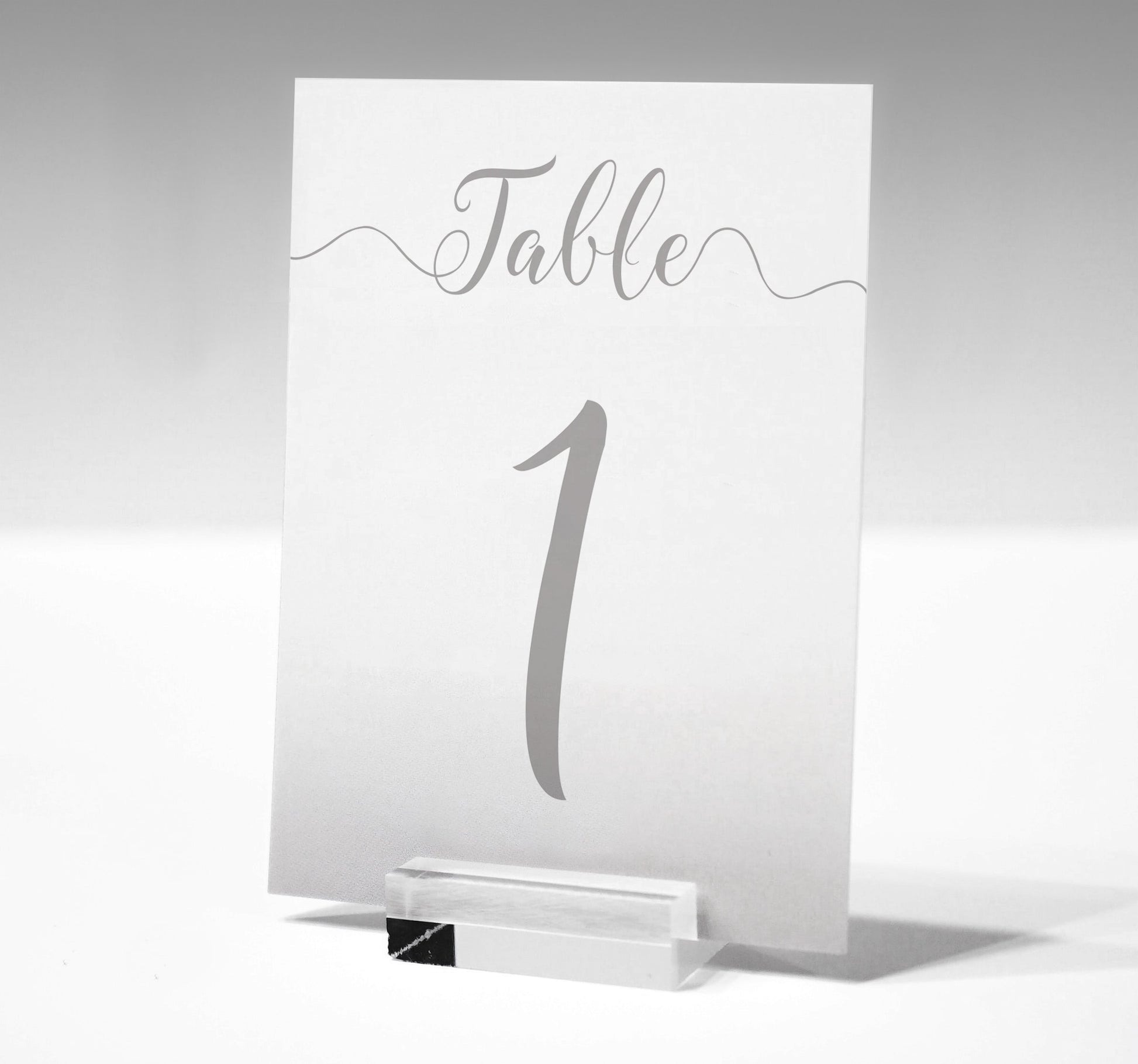 7x5 silver wedding table number printed on card in a glass stand