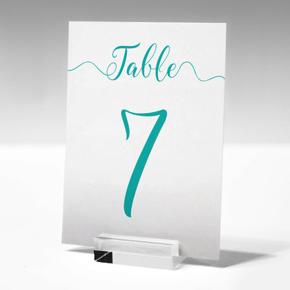 7x5 turquoise table number printed on card in a glass stand