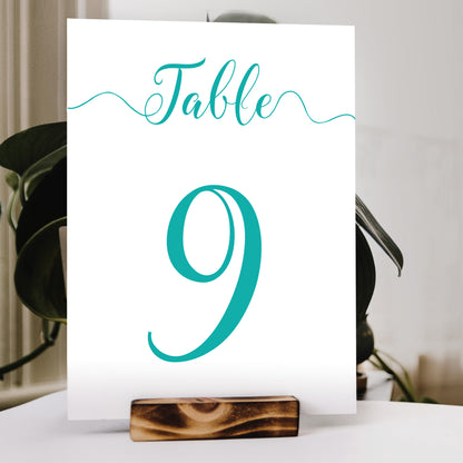 aqua table number print in a wooden stand at a wedding