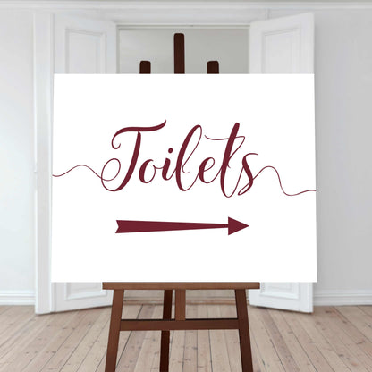 auburn wedding toilet directions sign with an arrow pointing right