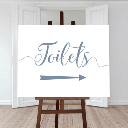 baby blue wedding toilet directions sign with an arrow pointing right