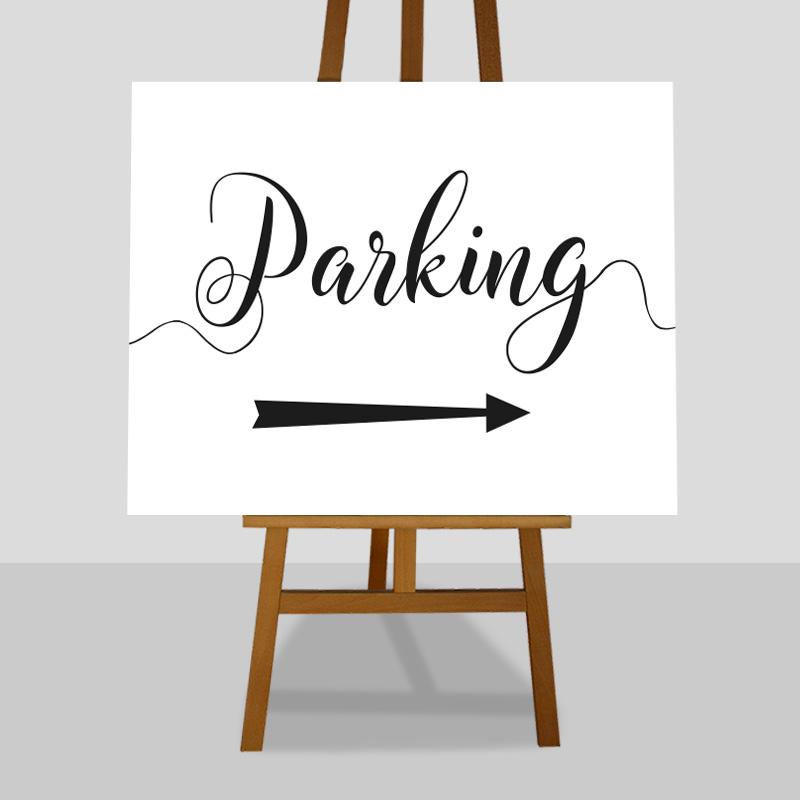 black and white parking sign with right arrow