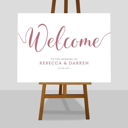 blush pink wedding welcome sign on easel