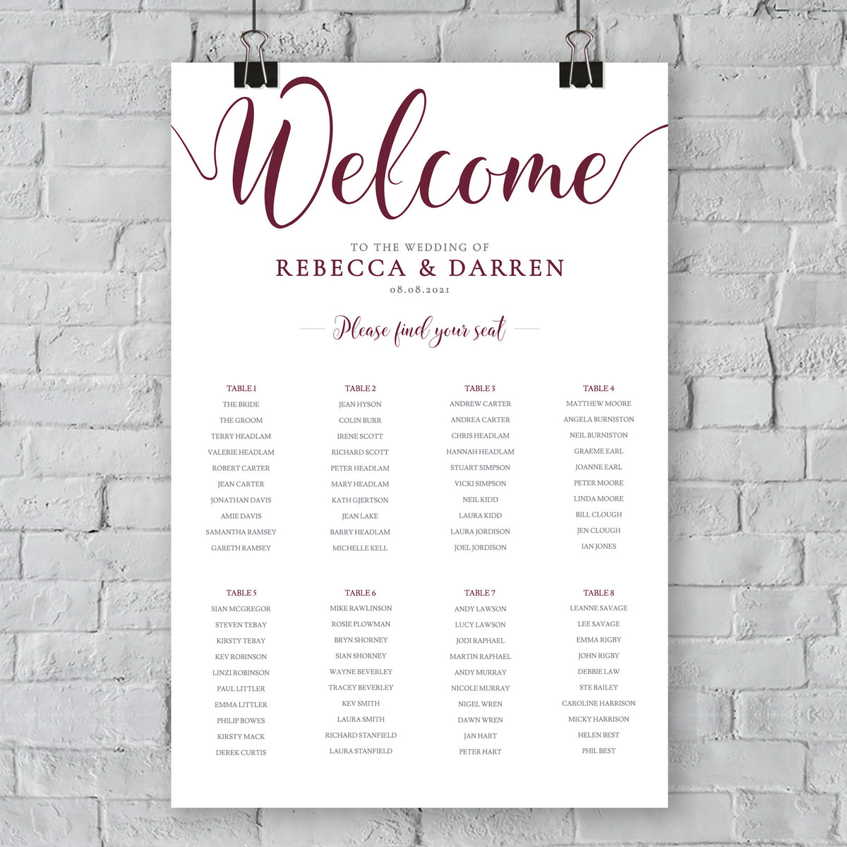 burgundy seating chart against a brick wall