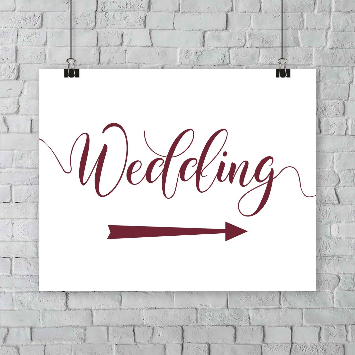 burgundy wedding arrow sign print hanging from a wall