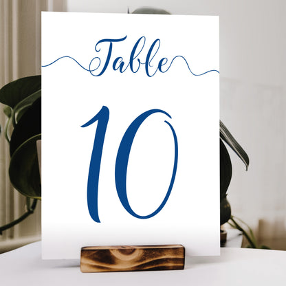 cobalt blue table number print in a wooden stand at a wedding