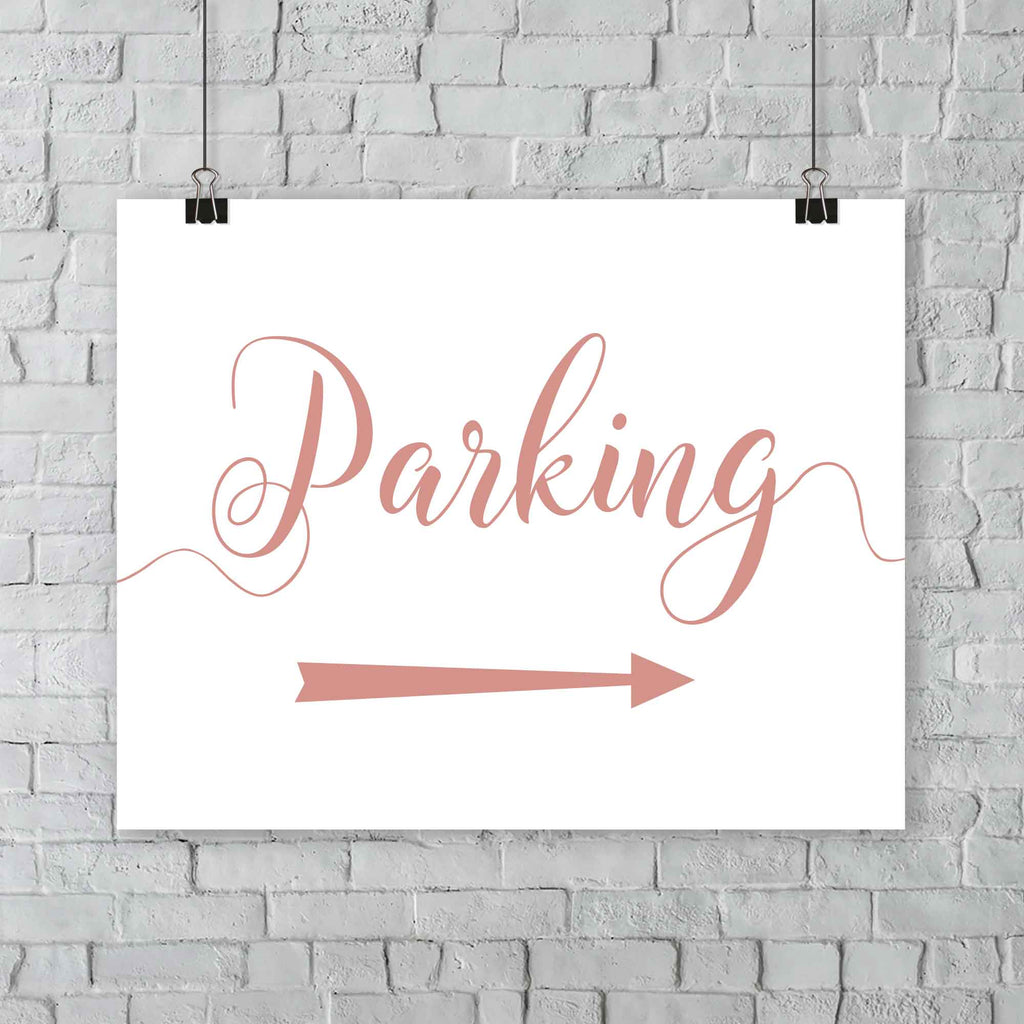 coral parking lot arrow sign hanging from a wall