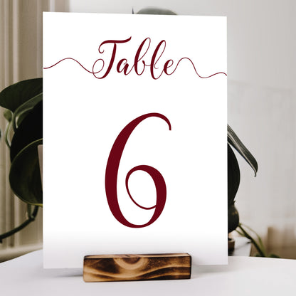 deep red table number print in a wooden stand at a wedding