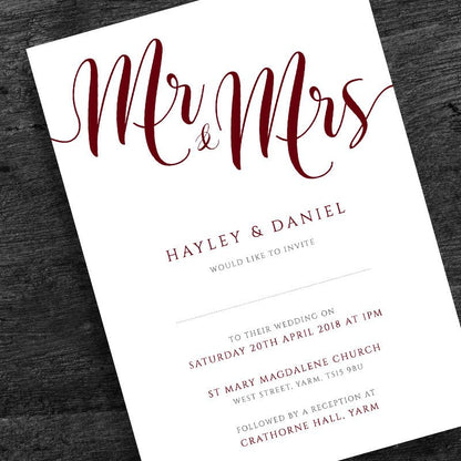 deep red wedding invitation on wooden table