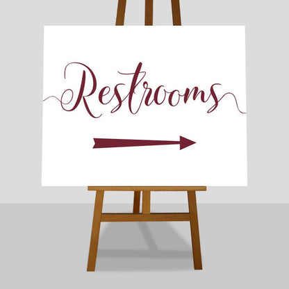 deep red wedding restrooms arrow sign on an easel