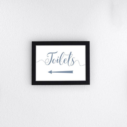 dusty blue directional toilets sign with left arrow printed and framed