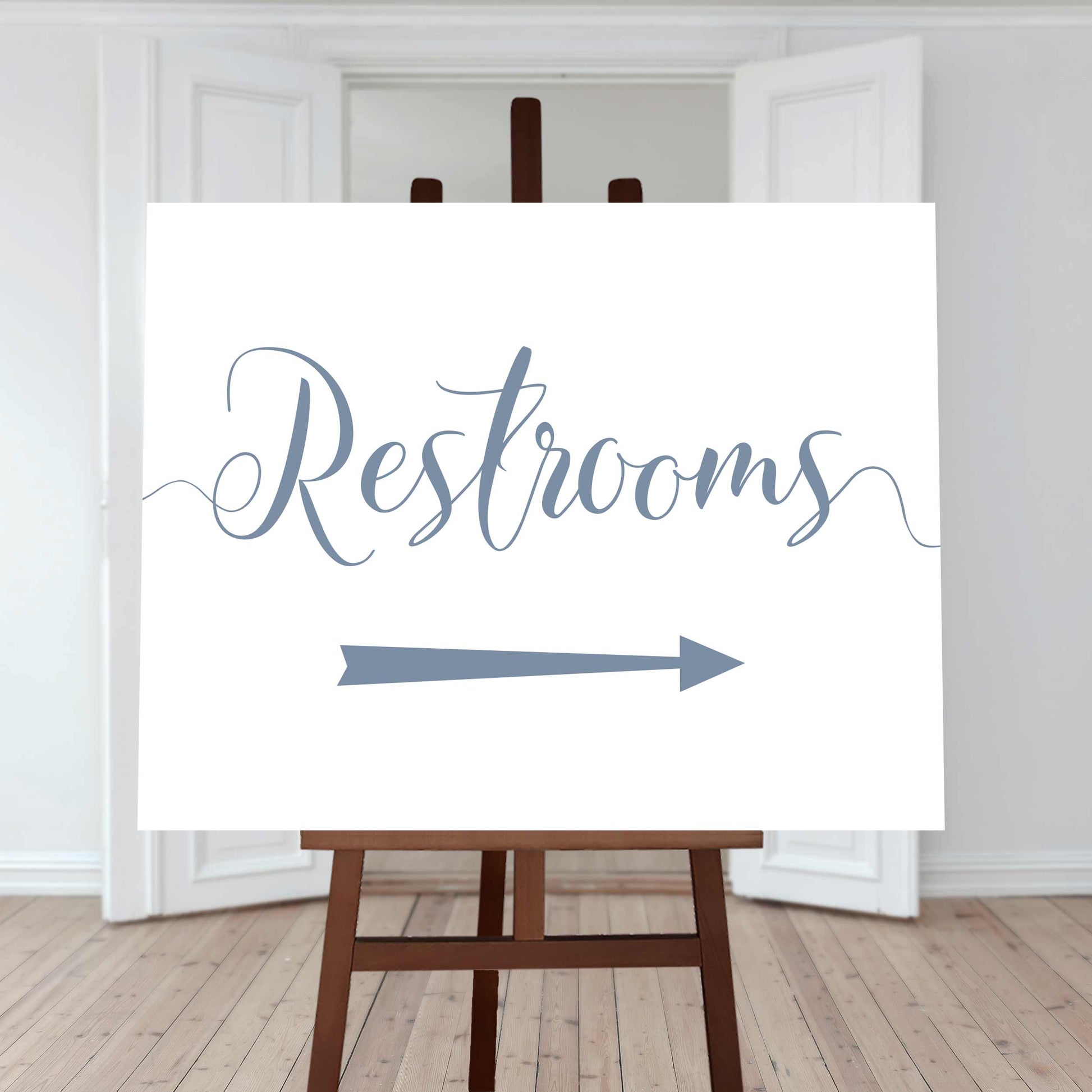 dusty blue restroom directions sign with an arrow pointing right