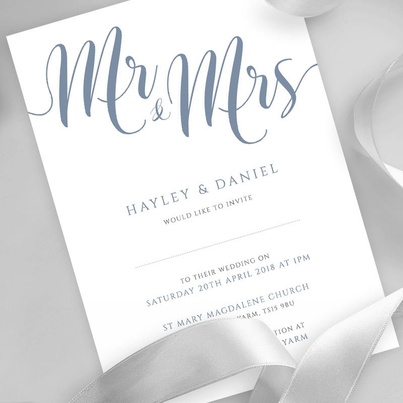 dusty blue wedding invitation printed on white card with ribbons overlayed
