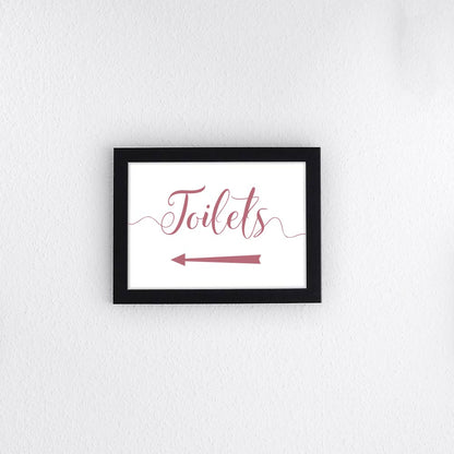 dusty pink directional toilets sign with left arrow printed and framed