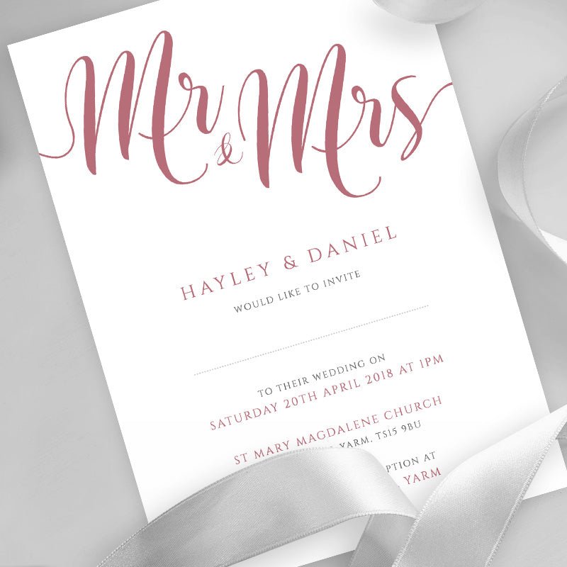 dusty pink wedding invitation printed on white card with ribbons overlayed