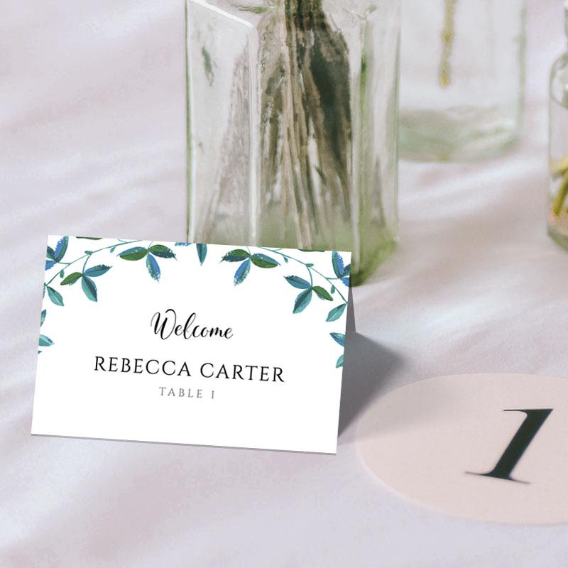 3.75"x2.5" folded name cards with eucalyptus border on a wedding table