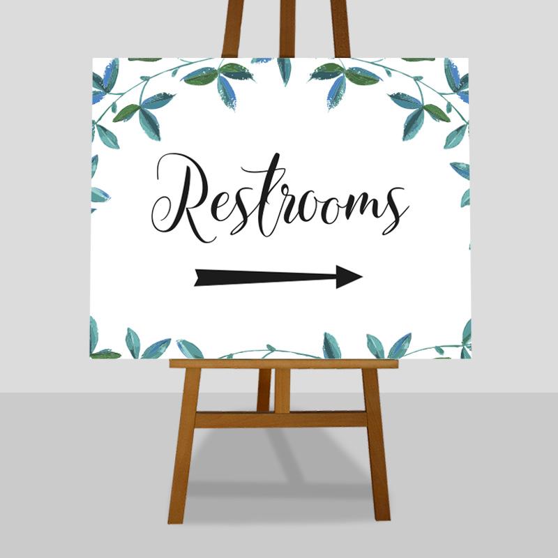 wedding restrooms directions sign with eucalyptus leaves
