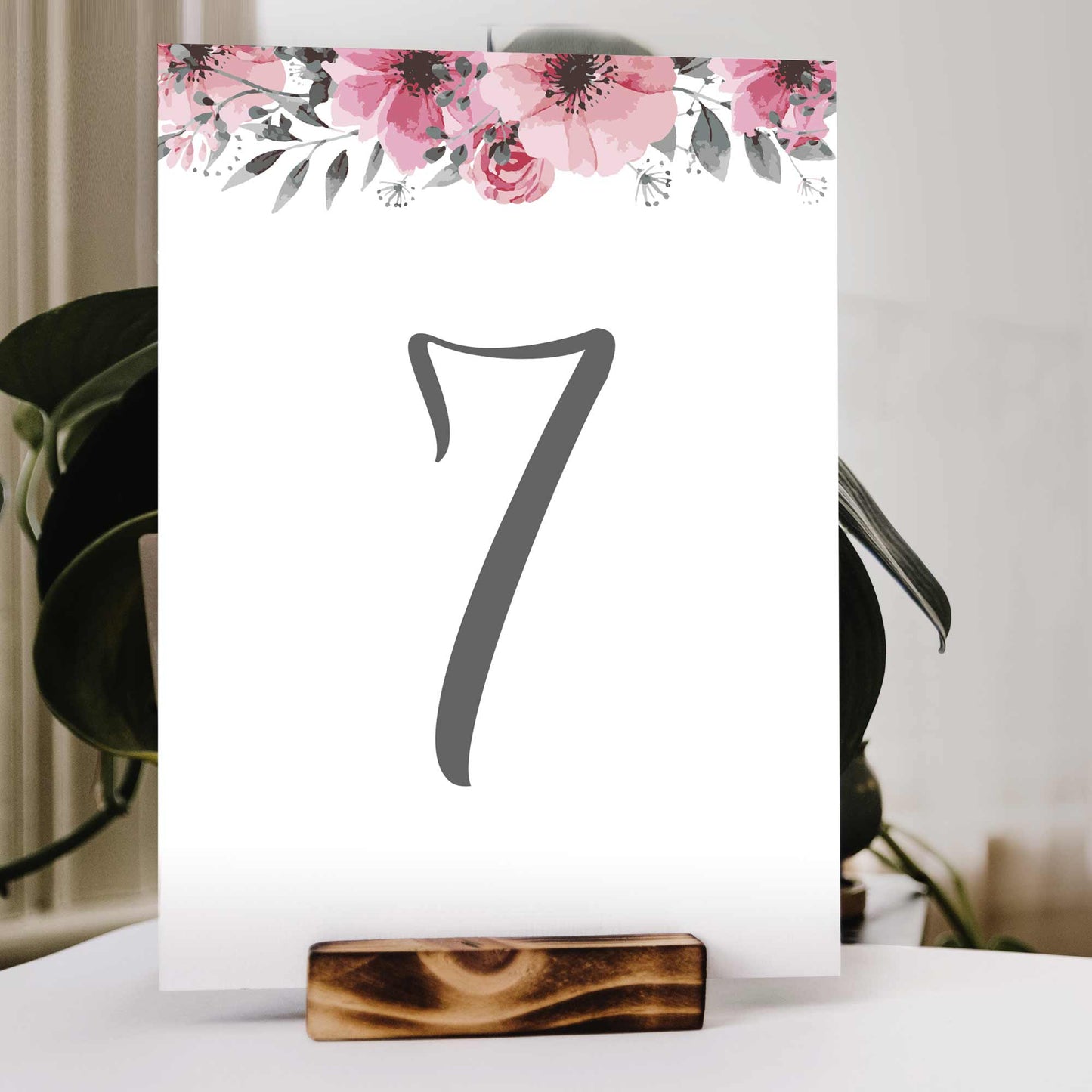 Table number 7 with pink flowers on a wedding table