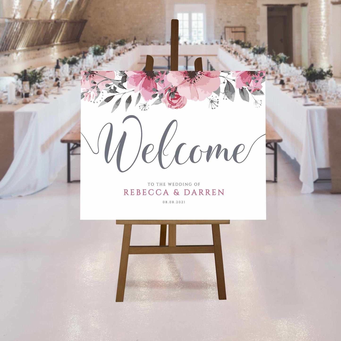 floral welcome sign at rustic wedding reception