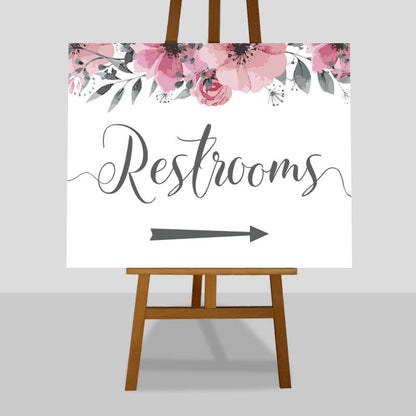 floral wedding restrooms sign on an easel