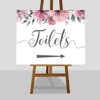 large floral wedding toilets arrow sign on an easel