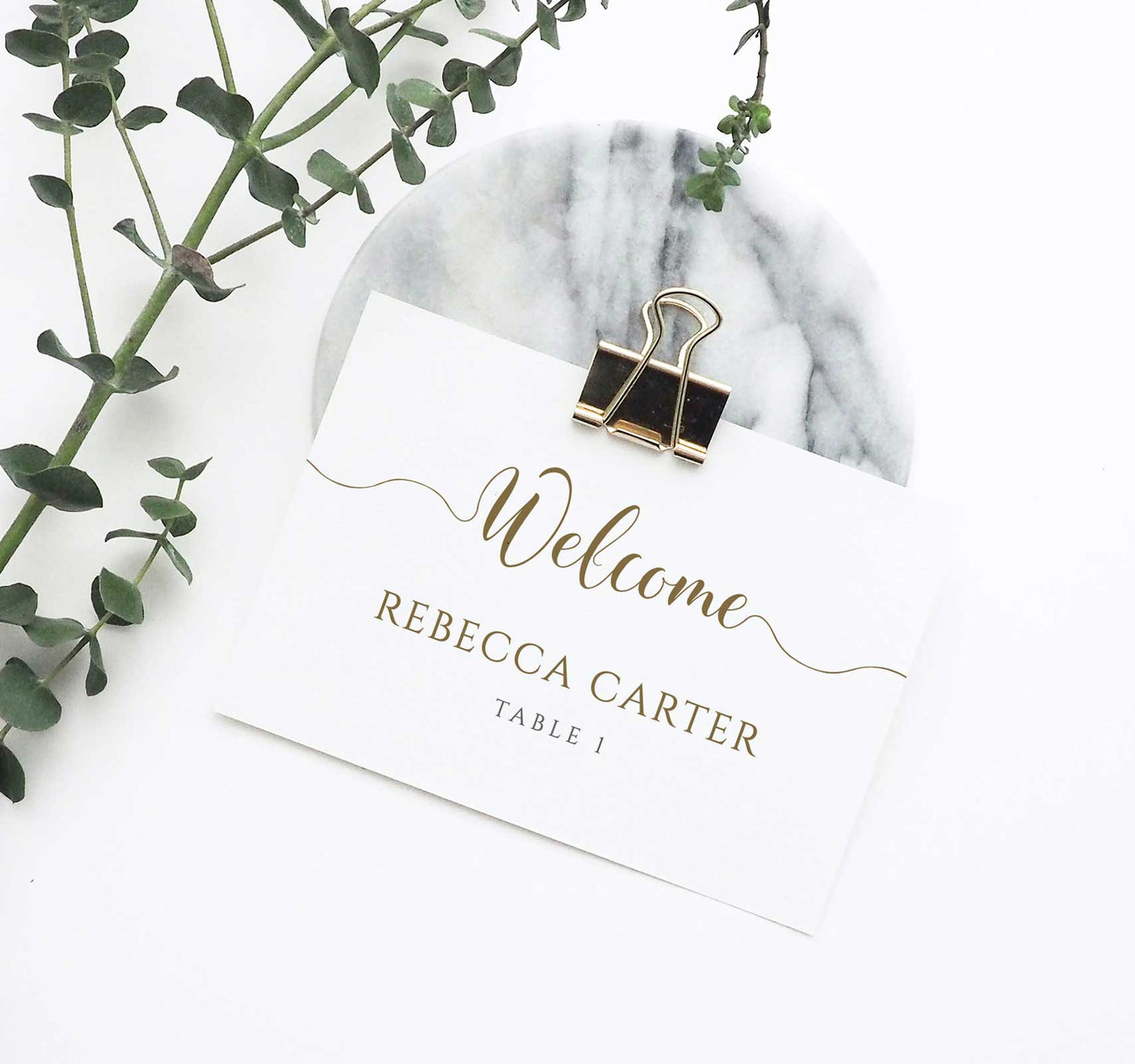welcome place card with gold text on wedding table
