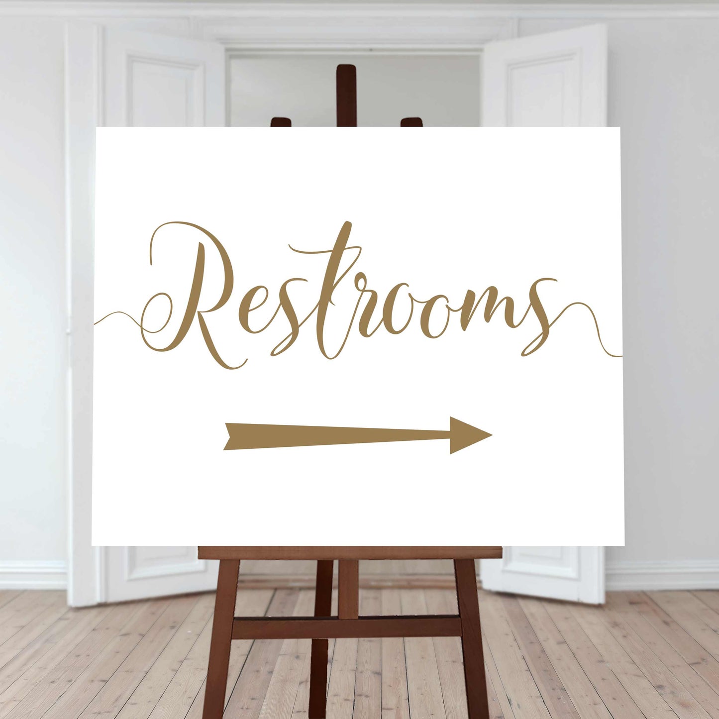 gold restrooms sign with a right arrow