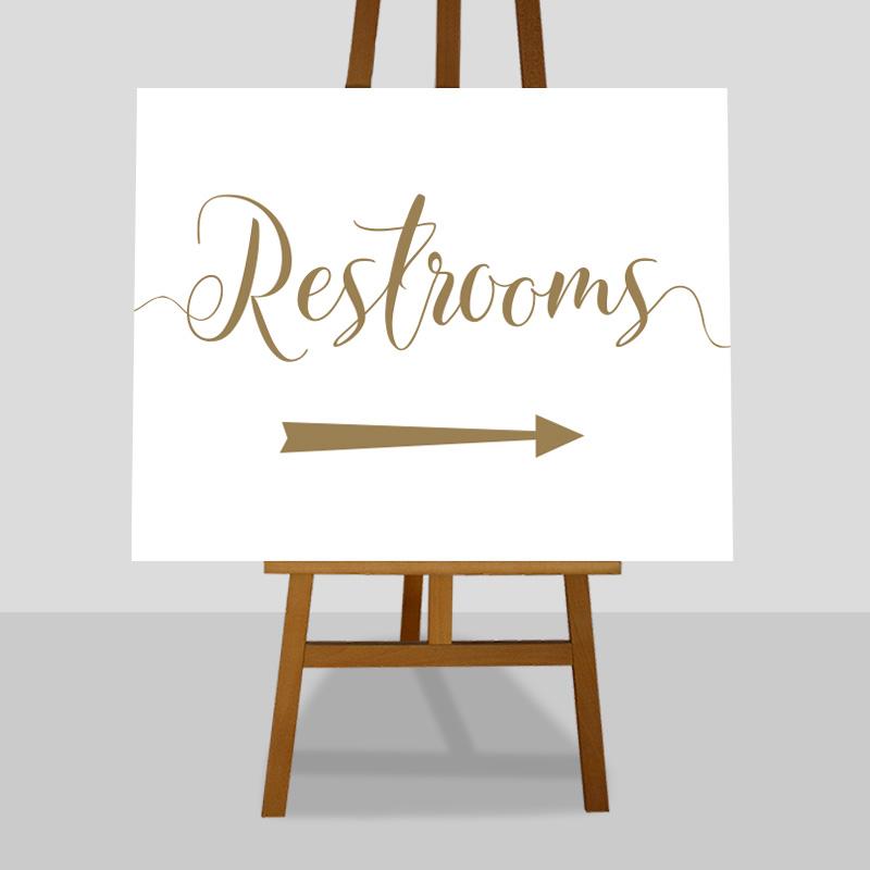 gold wedding restrooms sign with directional arrow